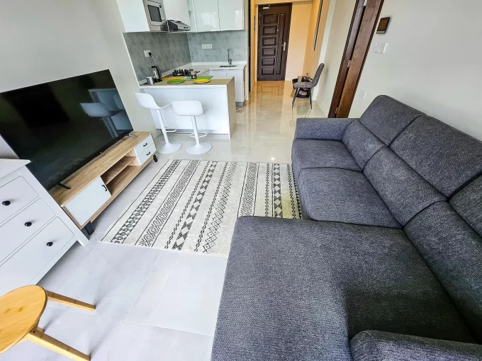 Fully furnished 1 bedroom luxury apartment in RainCoral Residence, 4th Floor, Hulhumale'. A photo of the living area, dining area and kitchen.